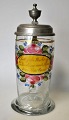 Deutscher 
Trinkbecher, 
19. Jh. Glas 
verziert mit 
Emaillefarben 
in Form von 
Blumen und 
Bändern, ...