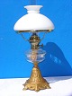 Old paraffin 
lamp with iron 
foot. Fine 
opaline glass 
globe from 
Holmegaard. 
Height 57cms. 
From 1900