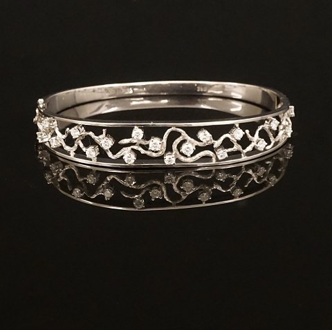 John Rørvig, Copenhagen, Denmark: A 18ct whitegold 
bangle with 18 diamonds. Size: 6,9x5,2cm