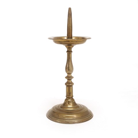 An early 17th century brass candlestick. H: 36cm