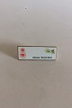 Bing & Grøndahl 
Dealer 
Advertising 
Sign "Klitrose 
/ Scotch Rose".
Measures 9,6cm 
x 3,7cm.