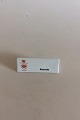 Bing & Grøndahl 
Dealer 
Advertising 
Sign "Aakande, 
Waterlillie".
Measures 9,6cm 
x 3,7cm.