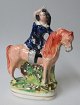 Staffordshire 
Steingut Figur 
mit Frau auf 
dem 
Pferderücken. 
ca. 1840. 
England. 
Polychrome ...