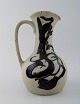 Mogens Andersen 
for Royal 
Copenhagen : 
Stoneware 
pitcher 
decorated with 
matt, grey 
glaze and ...