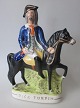 Staffordshire 
Figur, Räuber 
"Dick Turpin", 
gemalte 
Fajance, um 
1840, England. 
29 x 21 cm.
Dick ...