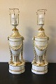 Royal 
Copenhagen A 
pair of 
baluster-shaped 
lamps on base 
decorated with 
garlands, Ram 
heads and ...