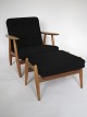 Hans J. Wegner armchair designed in 1954. Armchair of patinated oak and stool of patinated oak ...