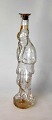 Figurenflasche 
aus klarem 
Glas, 1885. Der 
faule Junge. 
...