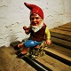 Painted pipe-smoking pixie in ceramic 