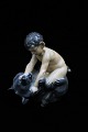 Royal 
Copenhagen 
porcelain 
figurine of Pan 
figurine 
sitting on 
bear. 
Decoration 
number: DJ648. 
...