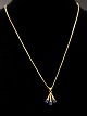 18 carat 
pendant 1.5 x 
1.3 cm. with 
small diamonds 
and sapphires 
and chain 43 
cm. Item No. 
508044