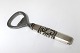 Georg Jensen. 
Scroll. 
Flaschenöffner. 
Silber (830). 
Länge 11cm