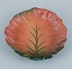 Ipsens, 
Denmark. 
Ceramic bowl 
with wavy rim.
Design 
depicting plant 
growth. Glaze 
in orange and 
...