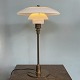 Poul 
Henningsen. 
Table lamp 
model TrePH, 
jubilee model 
with stem and 
base of bronzed 
brass, ...