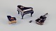 Limoges, 
France. Four 
porcelain 
musical 
instruments 
decorated with 
22-karat gold 
leaf and ...