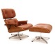 Eames Lounge chair with ottoman in red/brown colored leather. Nice condition. 
Chair H: 90cm. W: 84cm. D: 70cm. Ottoman: 65x55cm