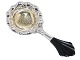 Danish silver 
tea strainer 
with guilding 
and ebony 
handle.
Hallmarked 
with "830S" and 
"DTA" ...