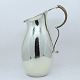 Karl Gustav 
Hansen for Hans 
Hansen. Pitcher 
of lightly 
hammered 
sterling 
silver, half of 
the ...