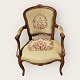 Armchair with 
embroidered 
floral cover, 
rococo-shaped, 
slightly 
age-related 
traces of use. 
...