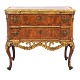 Reich 
dekorierte 
nussbaumfurnierte 
Kommode der 
Manufaktur 
Köster, Altona, 
um 1770
H: 78cm. ...