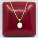 A necklace set 
with an opal 
mounted in 18k 
gold