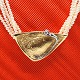 Ole Lynggaard; 
A triangular 
clasp made of 
14k gold and 
white gold with 
a brillant-cut 
diamond, ...