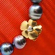 Ole Lynggaard; 
Small Flower 
clasp of 14k 
gold with a 
diamond