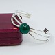 N. E. From silver jewellery.Niels Erik From; A sterling silver bangle set with a green ...
