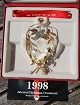 Weihnachtsmobile 
1998 Die 
weihnachtliche 
Getreidegarbe 
aus vergoldet 
Messing von 
Georg Jensen, 
...