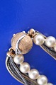 Ole Lynggaard 
Kugelschloss 
aus 14 Kt 
satiniertem 
Rotgold und 
Weissgold, 
verziert mit 2 
Diamanten ...