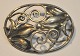 Silberbrosche 
Hugo Grün (nach 
1937) 
Kopenhagen, 
Dänemark. Oval. 
Dekoration in 
Form von ...