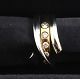 George Jensen. 
Magic Ring 
Weiß- & Rotgold 
18K mit 5 
Brillanten 
(750). 
Ringgröße 55. 
Design ...