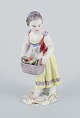 Meissen. 
Porcelain 
figurine of 
girl with 
basket.
