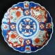 Japanischer 
Imari-
Porzellanteller, 
19. 
Jahrhundert. 
Mit polychromer 
Dekoration. 
Gewellter Rand. 
...
