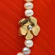 Ole Lynggaard, Charlotte Lynggaard; Clasp of 14k gold, ...