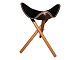 StoolBlack leather and foldable wooden legs