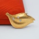 Ole Lynggaard; Brooch of 14k gold set with diamonds