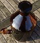Large and well-maintained 5 liter apothecary bottle with pouring spoutin in dark brown glass. On the back there are liter measurements.