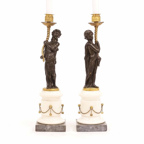 A pair of gilt bronze candle sticks. France circa 1810. H: 40,5cm