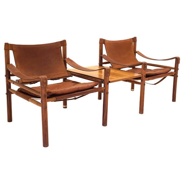 A pair of Arne Norell Scirocco rosewood safari chairs with table. Both chairs 
with original label. Design Sweden 1964