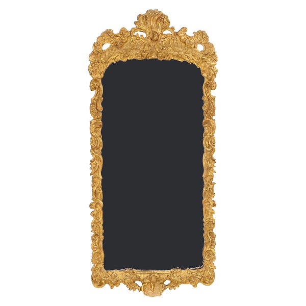 A gilt wood cut Rococo mirror. Denmark circa 1760. Measures: 114x52cm