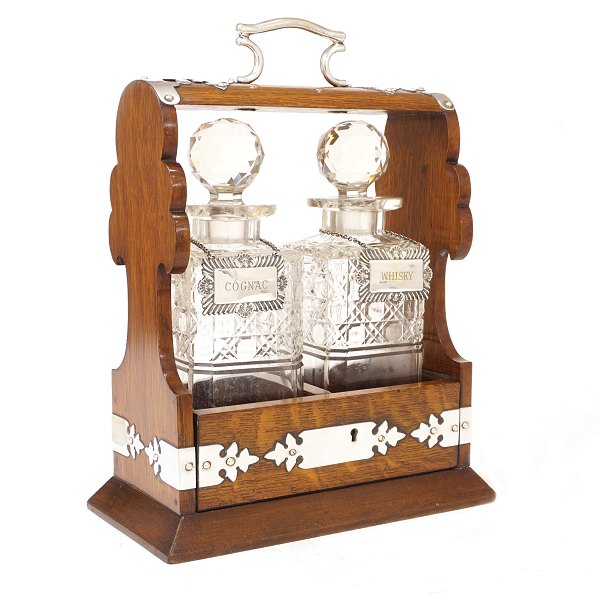 Tantalus in an oak box with two decanters. England circa 1880. H: 33cm. W: 25cm. 
D: 14cm