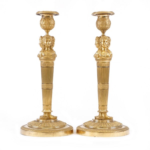 A pair of fire gilt bronze candlesticks. France circa 1810. H: 31cm