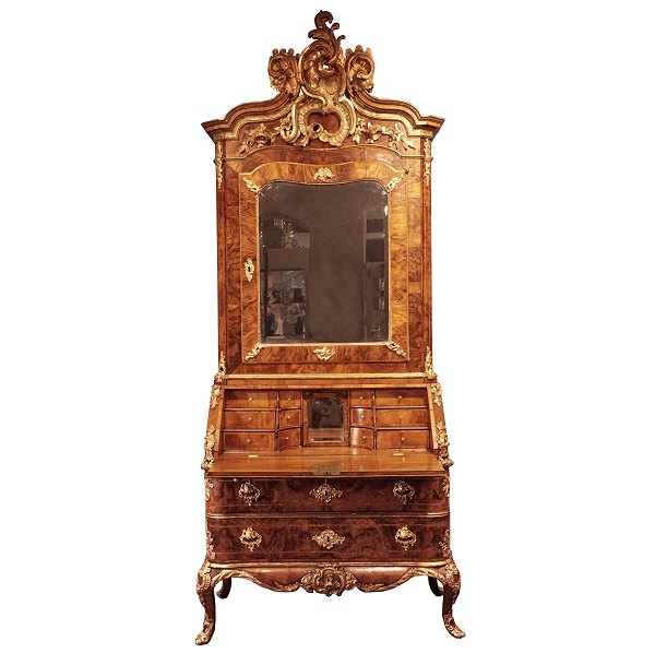 Signed Danish Rococo bureau from the royal castle Hirscholm by Mathias Ortmann, 
Copenhagen circa 1750. Gilt walnut with the original mirror. Ortmann was the 
leading Rococo cabinetmaker in Copenhagen.
H: 258cm. W: 110cm. D: 62c